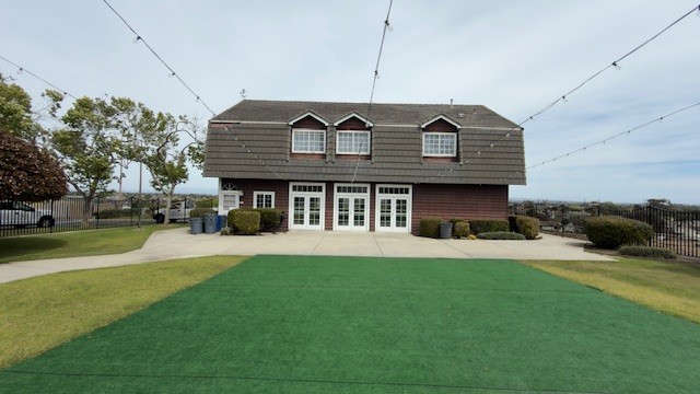 Newland Barn front — French doors, lawn, string lights